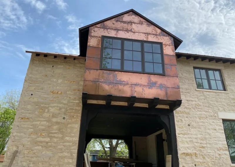 Copper metal panel facade on a stone building for Skylight Installation in Oakleaf Plantation