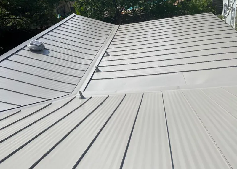 Solar attic fan installed on a metal roof for Roof Ventilation in Oakleaf Plantation